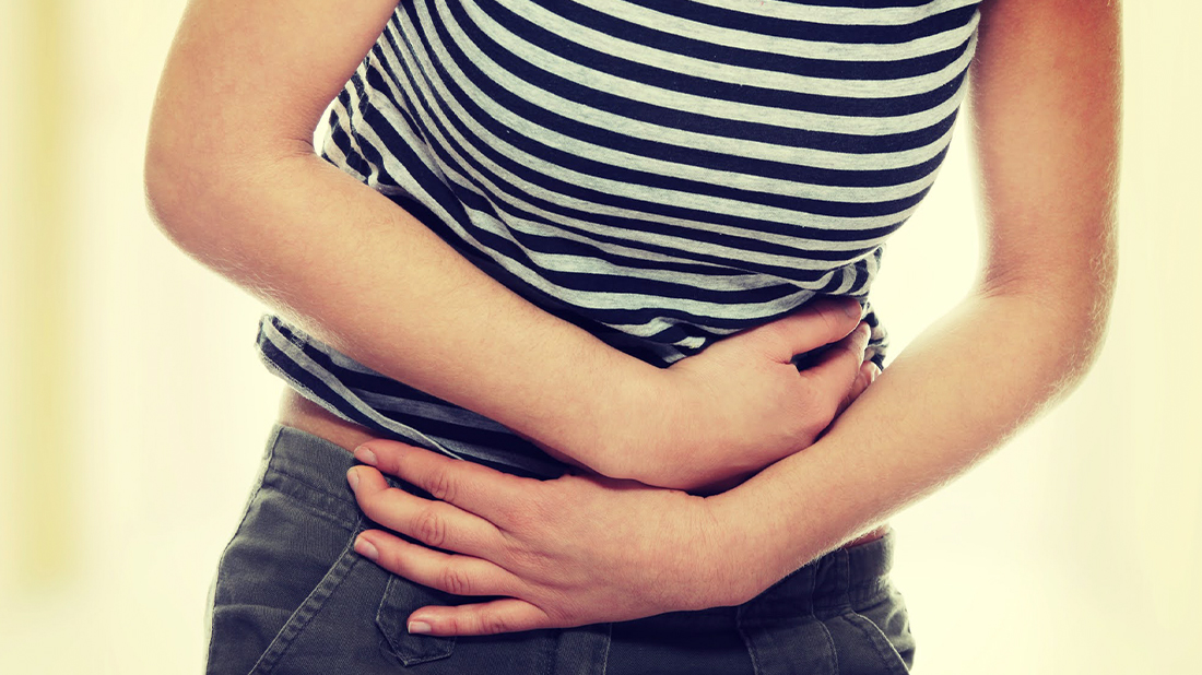Woman in discomfort holding her stomach